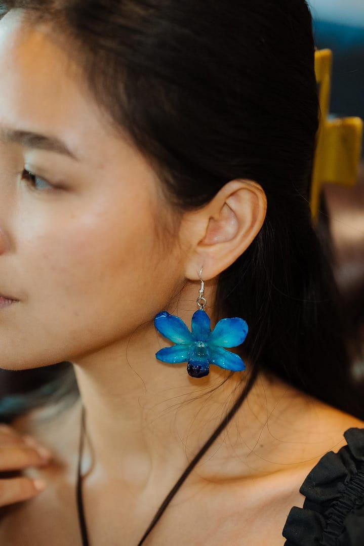 Model Wearing Wholesale Blue Orchid Flower Earrings Handmade in Thailand